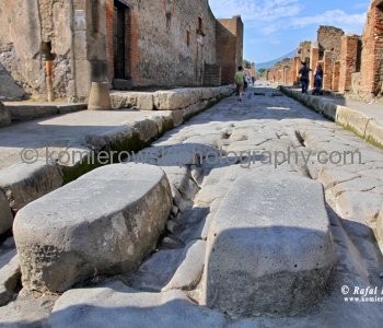 Roman street in Pompeii with chariot grooves in the stone and stepping stones for pedestrians
