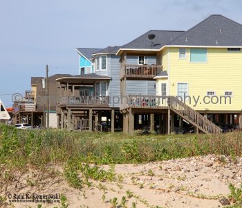 Homes atop tall concrete or wooden stilts. They are built to withstand hurricane winds as well as the most severe flooding