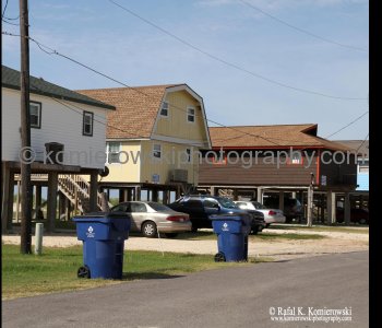 Homes atop tall concrete or wooden stilts. They are built to withstand hurricane winds as well as the most severe flooding