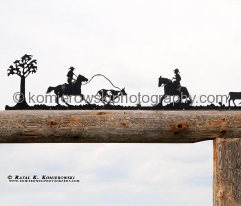 Steel silhouette entrance gate as seen from the Cowboy Trail near Priddis